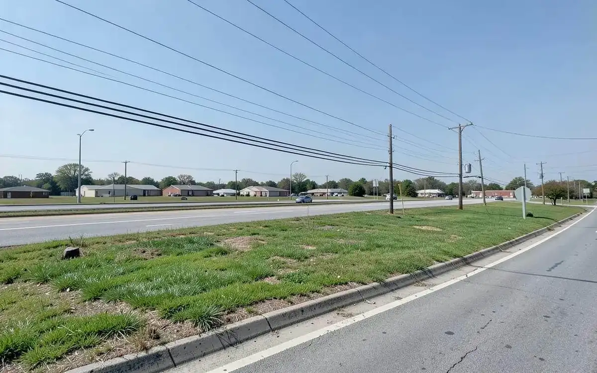 Cleared highway frontage parcel along a four-lane road in a North Mississippi city